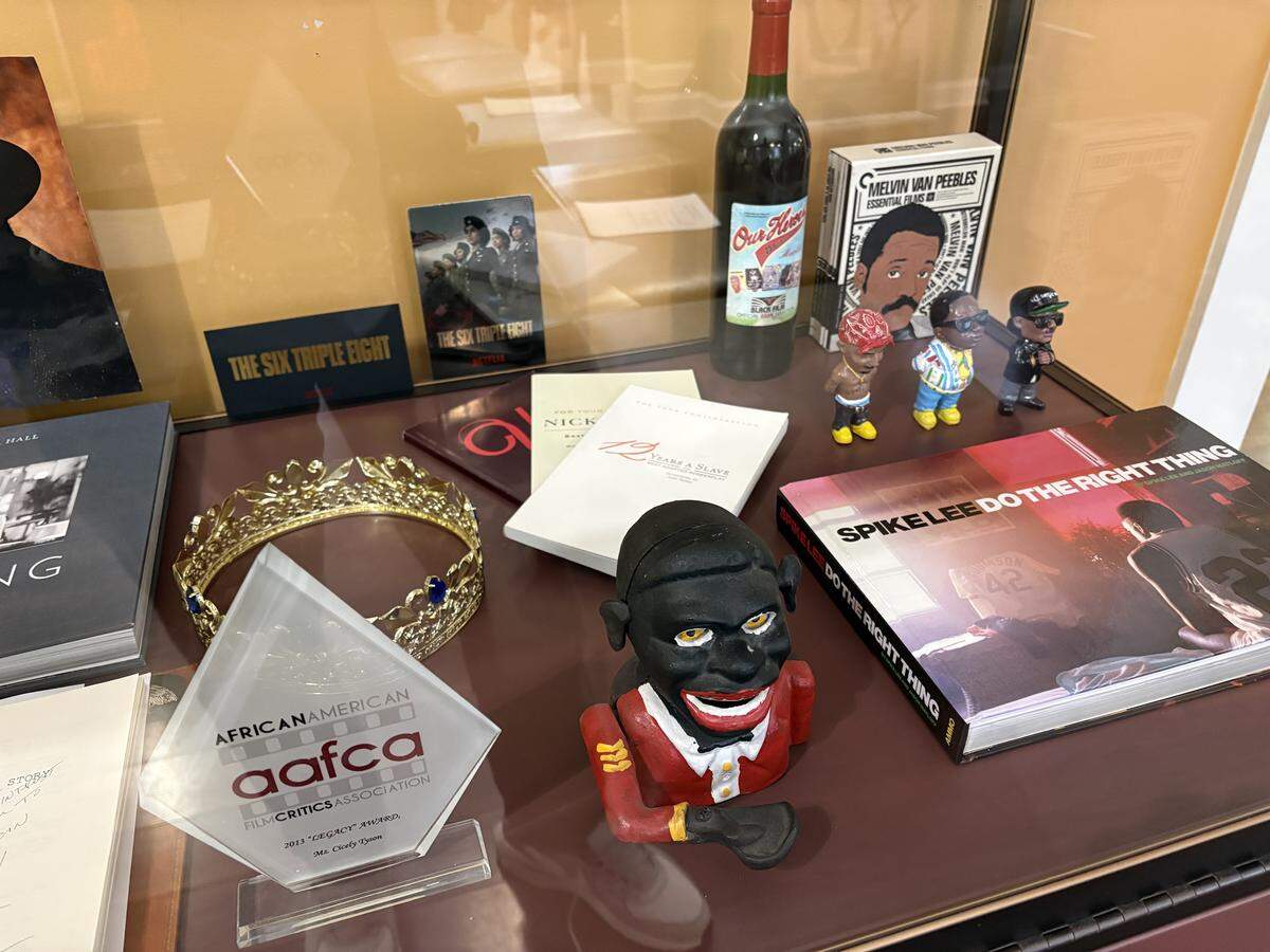 The Black Movie Hall of Fame exhibit features artifacts like an animation cel from “The Princess and the Frog,” items from recent films like “Sinners,” and Cicely Tyson’s 2013 AFCA award.