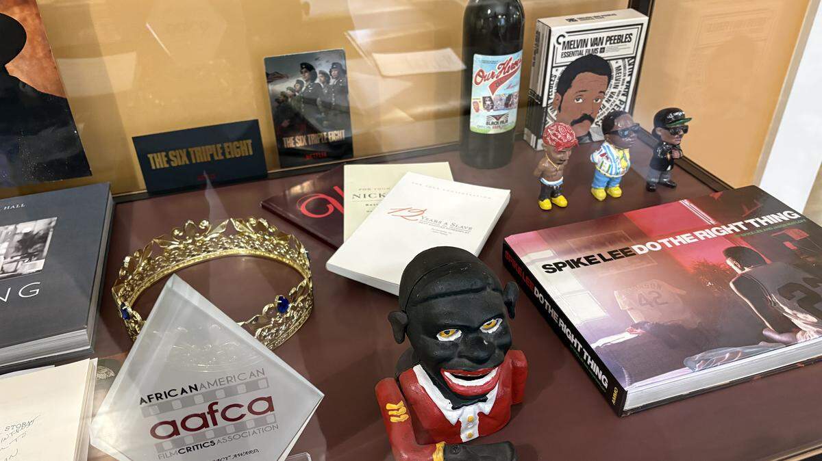 The Black Movie Hall of Fame exhibit features artifacts like an animation cel from “The Princess and the Frog,” items from recent films like “Sinners,” and Cicely Tyson’s 2013 AFCA award.