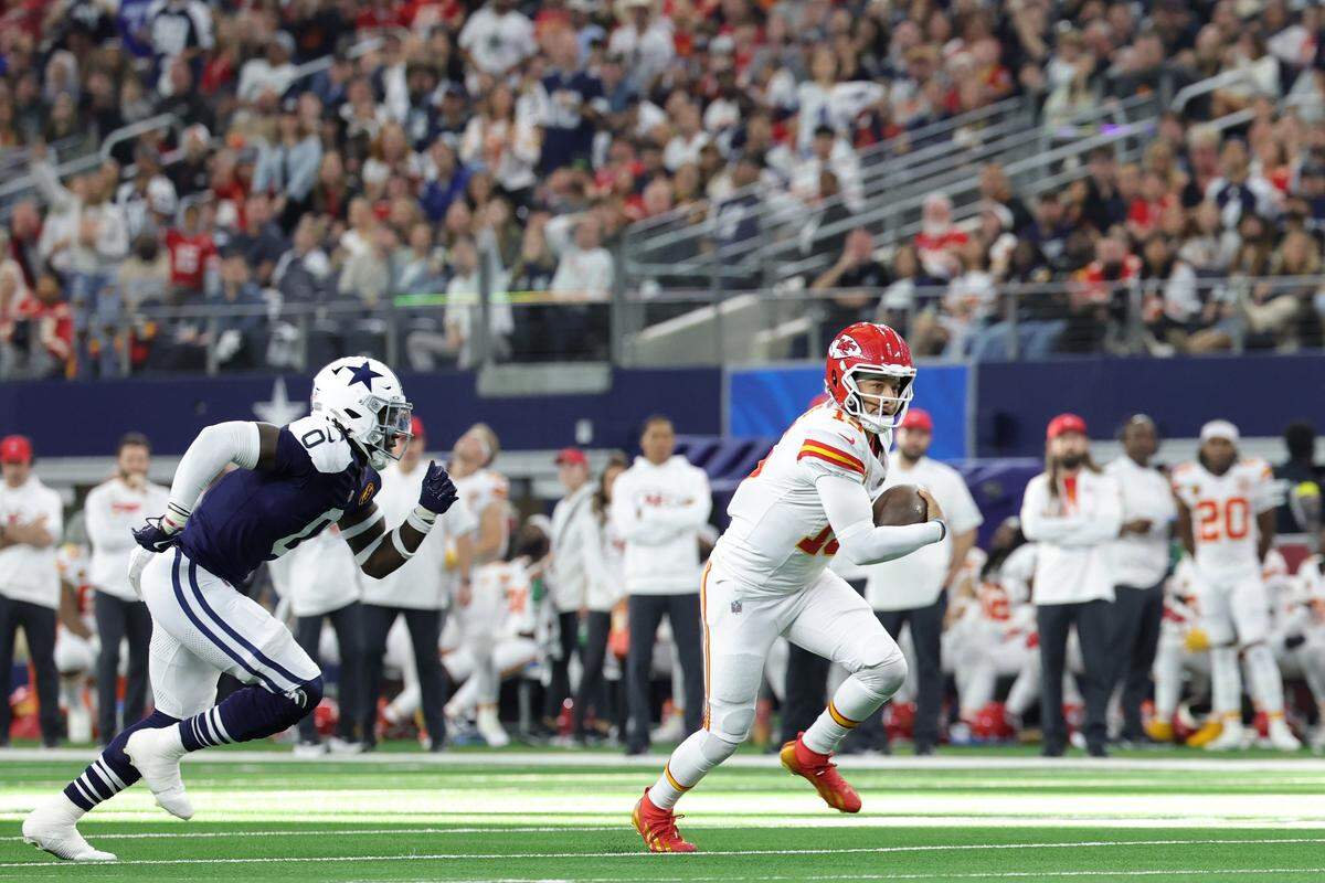 Kansas City Chiefs quarterback Patrick Mahomes, right, scrambles for a first down against the Dallas Cowboys during an NFL Week 13 Thanksgiving Day game at AT&T Stadium in Arlington, Texas on Thursday, Nov. 27, 2025.