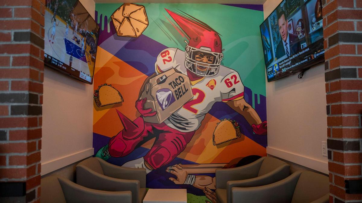 The Kansas City Chiefs and other local teams adorn the walls, including this small private seating area, at the new Taco Bell Cantina in Westport.
