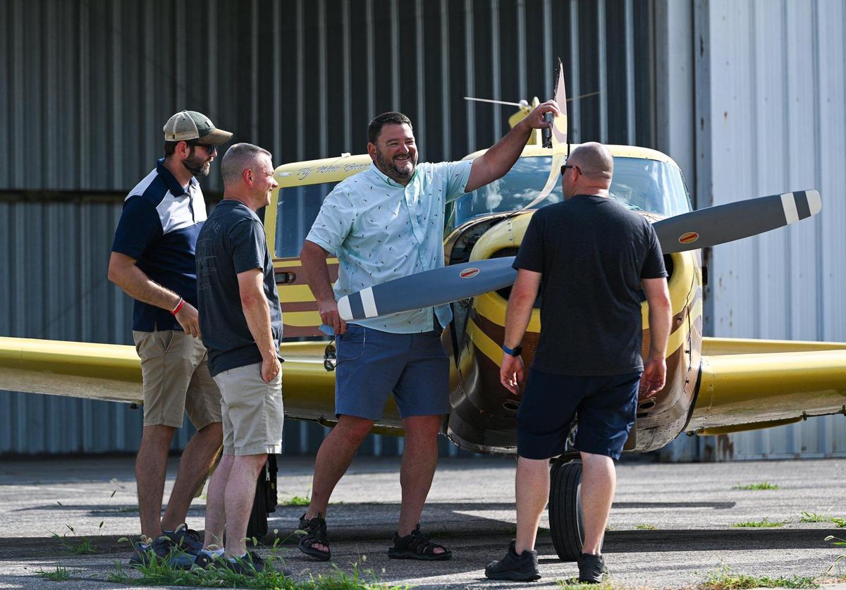 Kenyon Gleason, center, spends a late afternoon at Billard Municipal Airport with, from left, air traffic control tower manager Brad Miller and pilots Russ Moore and Jason Klenklen. Members of the “Billard Boys” have welcomed the South Dakota transplant into their tight-knit flying club.