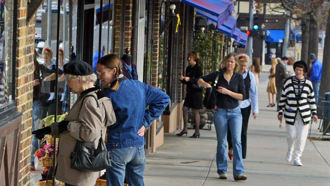 Shoppers peruse the shops along 63rd Street on Saturday at the Brookside shops. 

cutline: An old-fashioned shopping district, shady walks and colorful awnings attract plenty of Brookside shoppers.