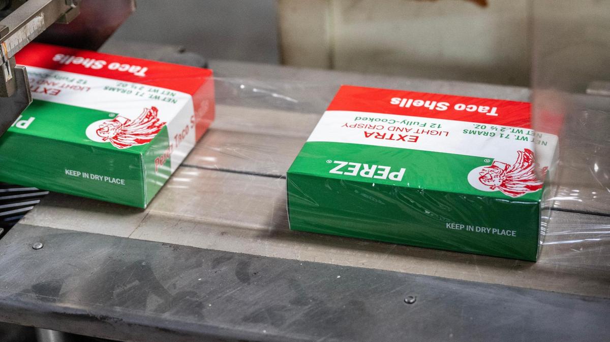 A machine wraps boxes of taco shells in clear plastic at Perez Food Products on Thursday in Kansas City.