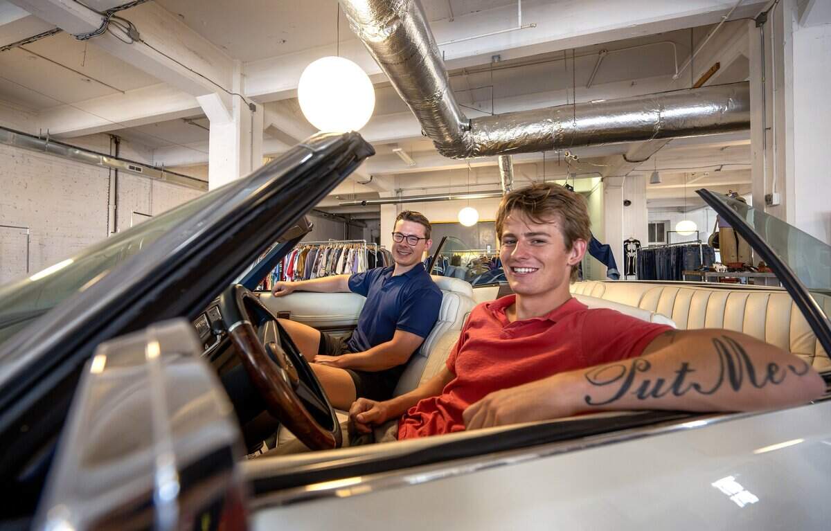 Brothers Thomas Rex, left, and Reade Rex, owners of Rex, sit inside their grandfather Lonnie R. Rex's vintage Cadillac for a portrait at the store on Wednesday, July 15, 2026, in Kansas City.