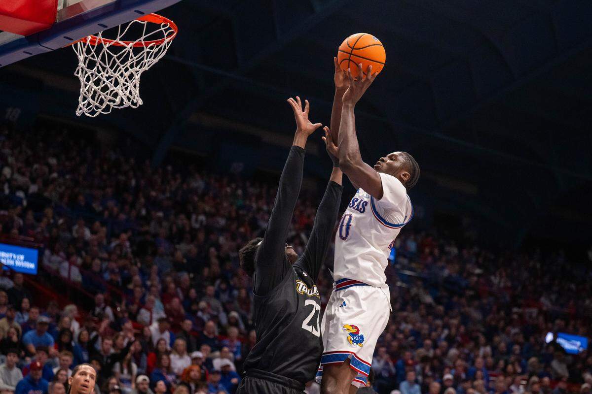 Kansas Jayhawks forward Flory Bidunga (40) shoots a layup over a Towson Tigers player in the first half on Tuesday, December 16, 2025, at Allen Fieldhouse.