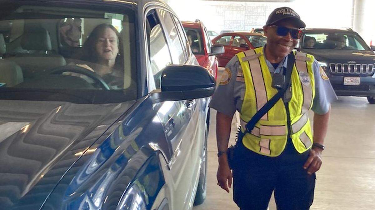 KCI Traffic Officer Clyde Kemp, 64, asks driver Beth Fagala of Kansas City to move from the curb outside the airport terminal. Fagala of Kansas City has come to pick up her brother from Tampa, Florida. “I’m fine with this,” she said of the request to move.