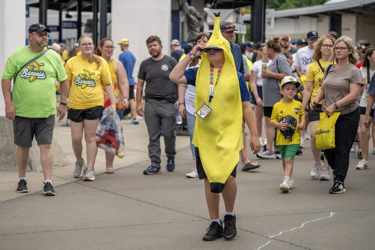 Eleven-year-old Jack Thomas wears a banana costume while attending a Banana Ball game between the Savannah Bananas and Indianapolis Clowns at Kauffman Stadium on Saturday, May 30, 2026, in Kansas City.