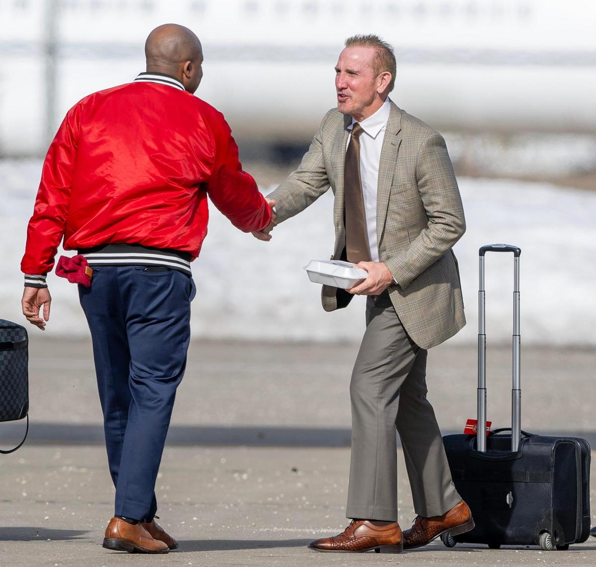 Kansas City Mayor Quinton Lucas shakes hands with Kansas City Chiefs defensive coordinator Steve Spagnuolo before he boards a plane at Kansas City International Airport for a flight to New Orleans for Super Bowl LIX on Sunday, Feb. 2, 2025.