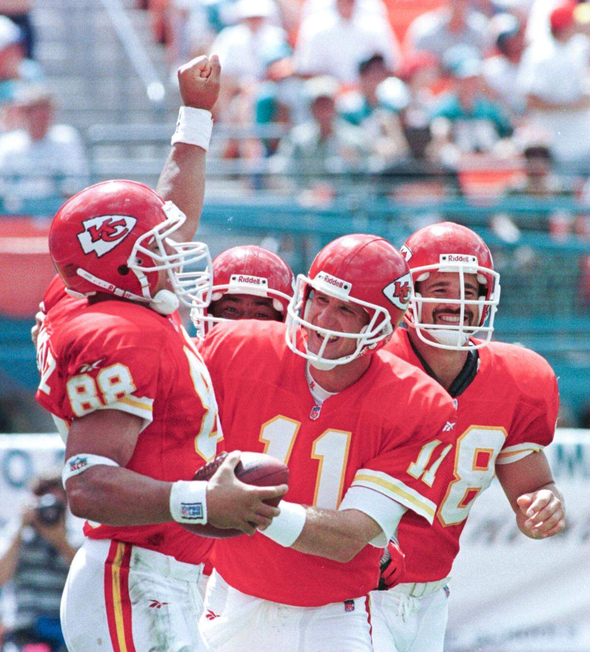 Kansas City Chiefs tight end Tony Gonzalez (88) was happy after catching the ball for his first NFL touchdown as his teammates Elvis Grbac (11) who threw the ball, tight end Ted Popson, right, and Andre Rison, behind, joined in the celebration during the Chiefs’ game with the Miami Dolphins on Oct. 5, 1997, in Miami.