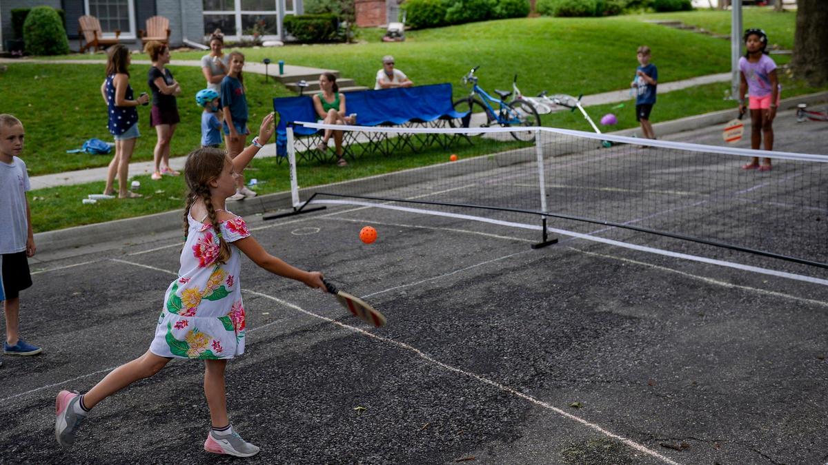 Quinn Barber, 7, plays pickleball on Arno Road with her neighbors.