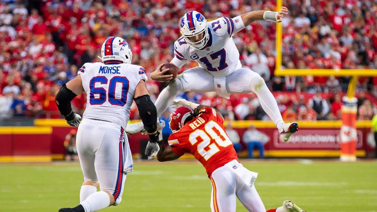 Buffalo Bills quarterback Josh Allen leaps over Kansas City Chiefs safety Justin Reid during Sunday’s game at GEHA Field at Arrowhead Stadium.