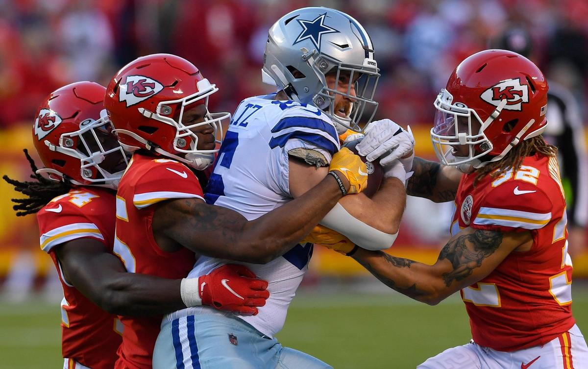 Kansas City defenders Nick Bolton, left, Charvarius Ward and Tyrann Mathieu wrap up Dallas tight end Dalton Schultz during the first quarter of Sunday’s NFL game at Arrowhead Stadium. Kansas City beat Dallas, 19-9.