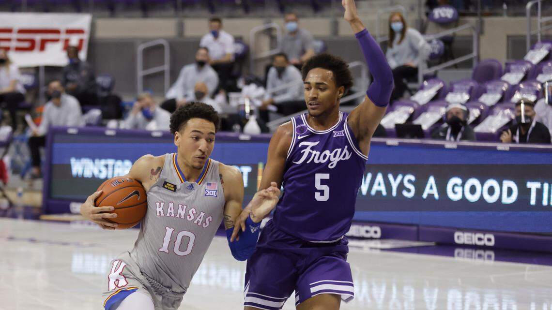 Kansas forward Jalen Wilson (10) drives inside as TCU forward Chuck O’Bannon Jr. (5) defends during the first half of an NCAA college basketball game, Tuesday, Jan. 5, 2021, in Fort Worth, Texas. (AP Photo/Ron Jenkins)