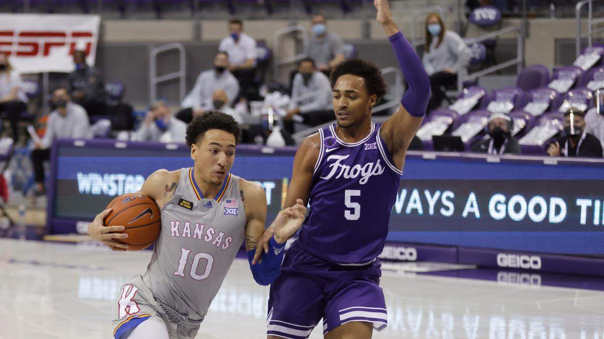 Kansas forward Jalen Wilson (10) drives inside as TCU forward Chuck O’Bannon Jr. (5) defends during the first half of an NCAA college basketball game, Tuesday, Jan. 5, 2021, in Fort Worth, Texas. (AP Photo/Ron Jenkins)