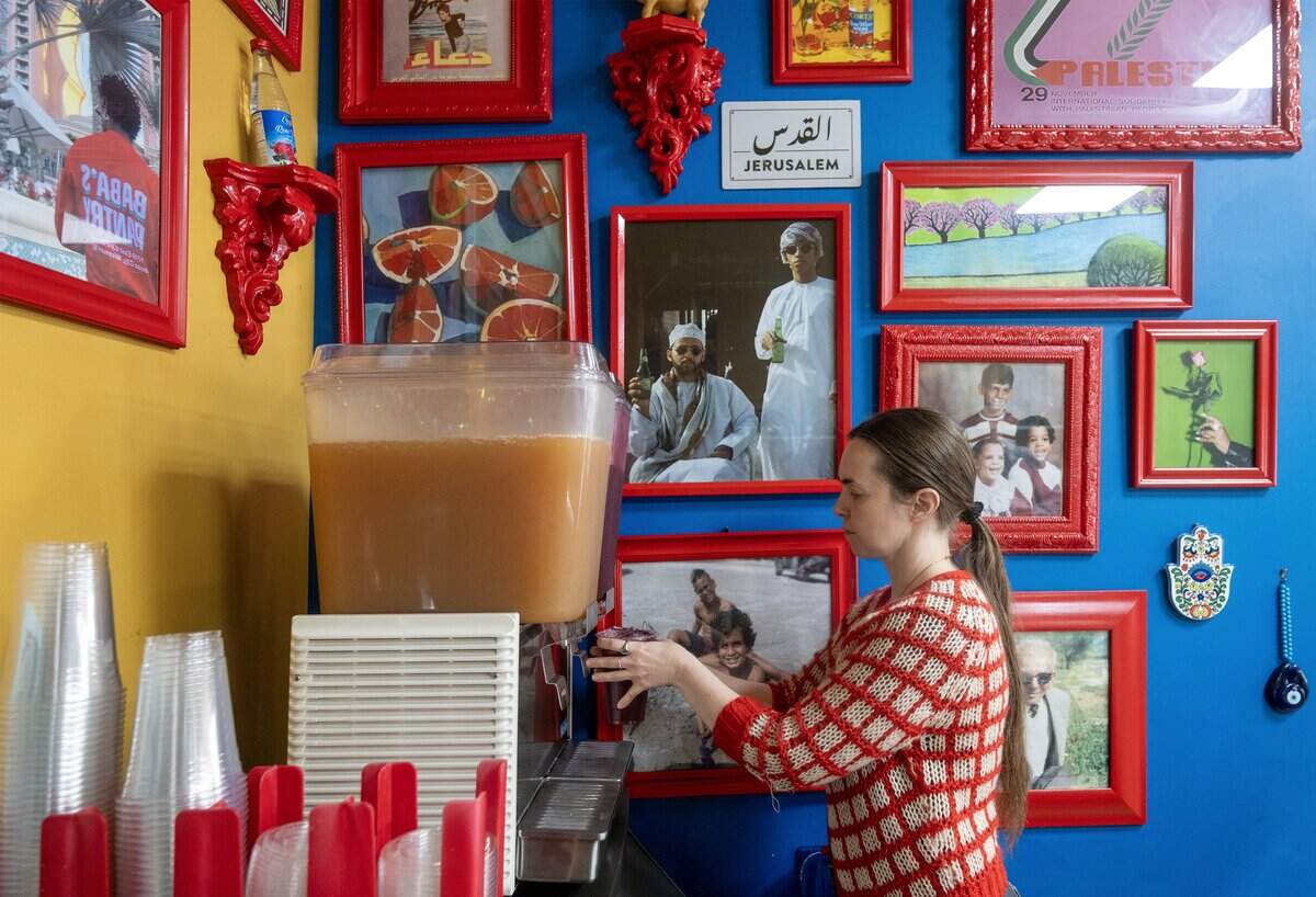 Employee Laura Evrard fills an order for Cream of Berry lemonade at Baba's Pantry, an authentic Palestinian-American deli and cafe on Tuesday, May 19, 2026, in Kansas City.