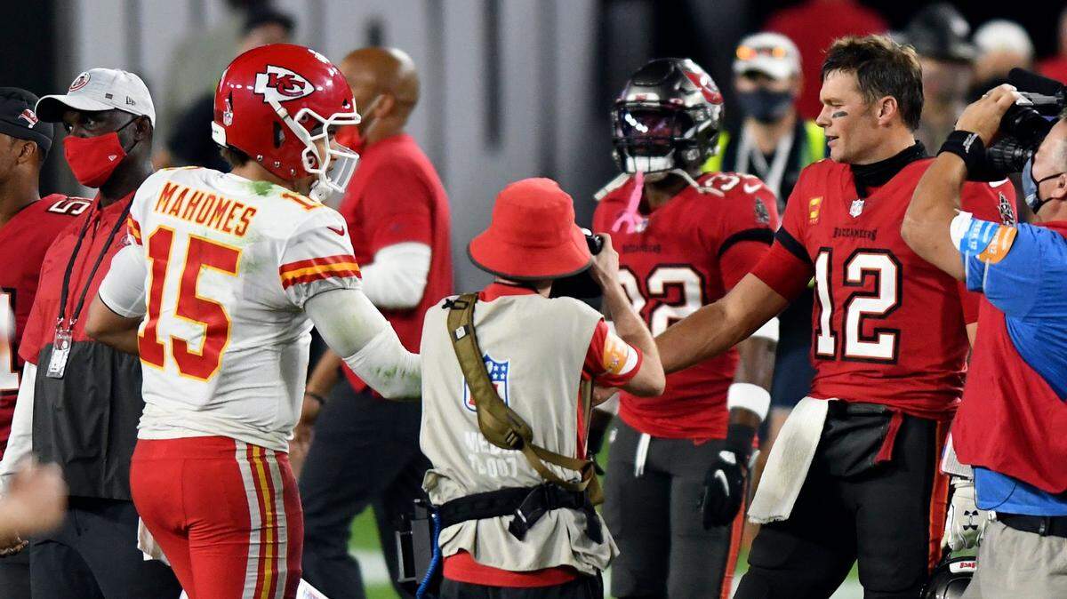 Chiefs quarterback Patrick Mahomes, left, meets up with Bucs QB Tom Brady after Kansas City’s win in Tampa Sunday evening.
