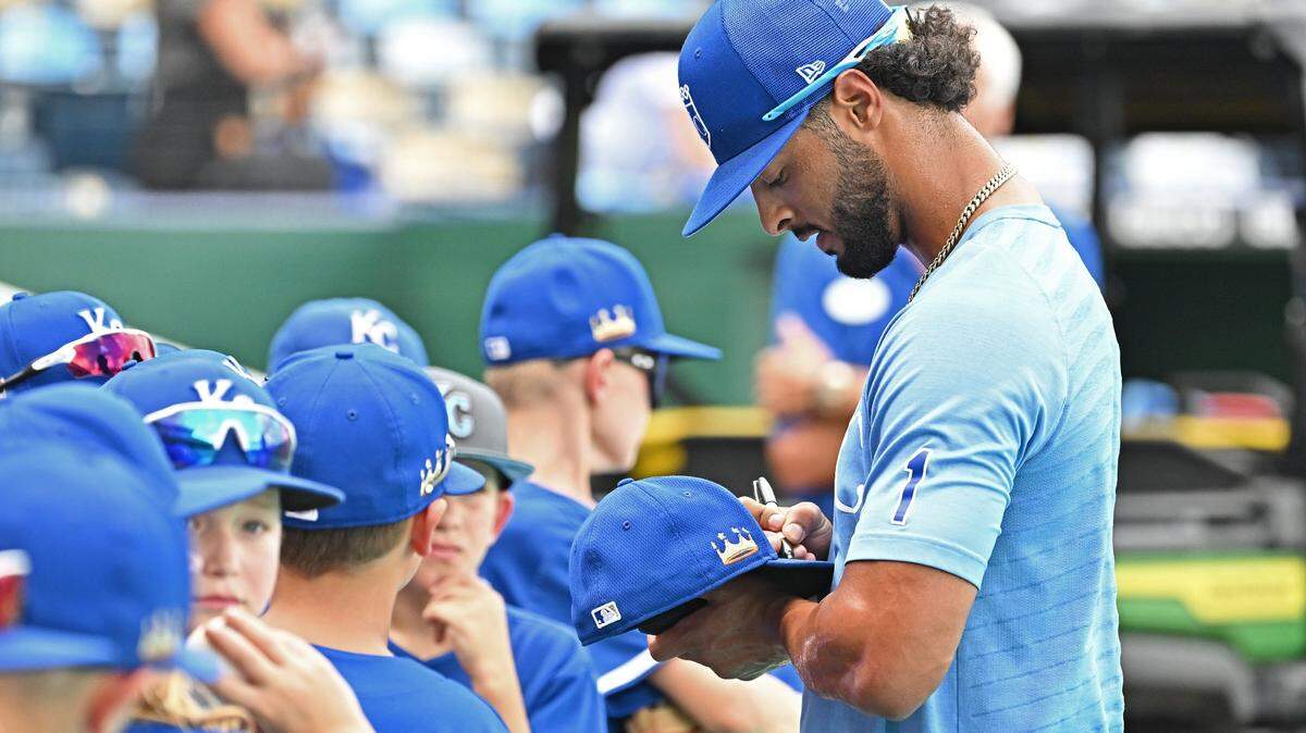 Kansas City Royals left fielder MJ Melendez (1) signs autographs for fans before a game against the Boston Red Sox at Kauffman Stadium.