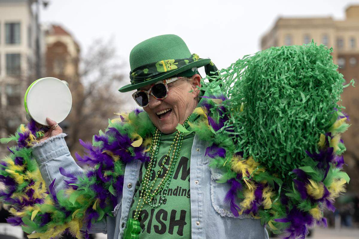 Sherry Haddock dances during the St. Patrick's Day parade along Broadway Boulevard on Tuesday, March 17, 2026, in Kansas City.