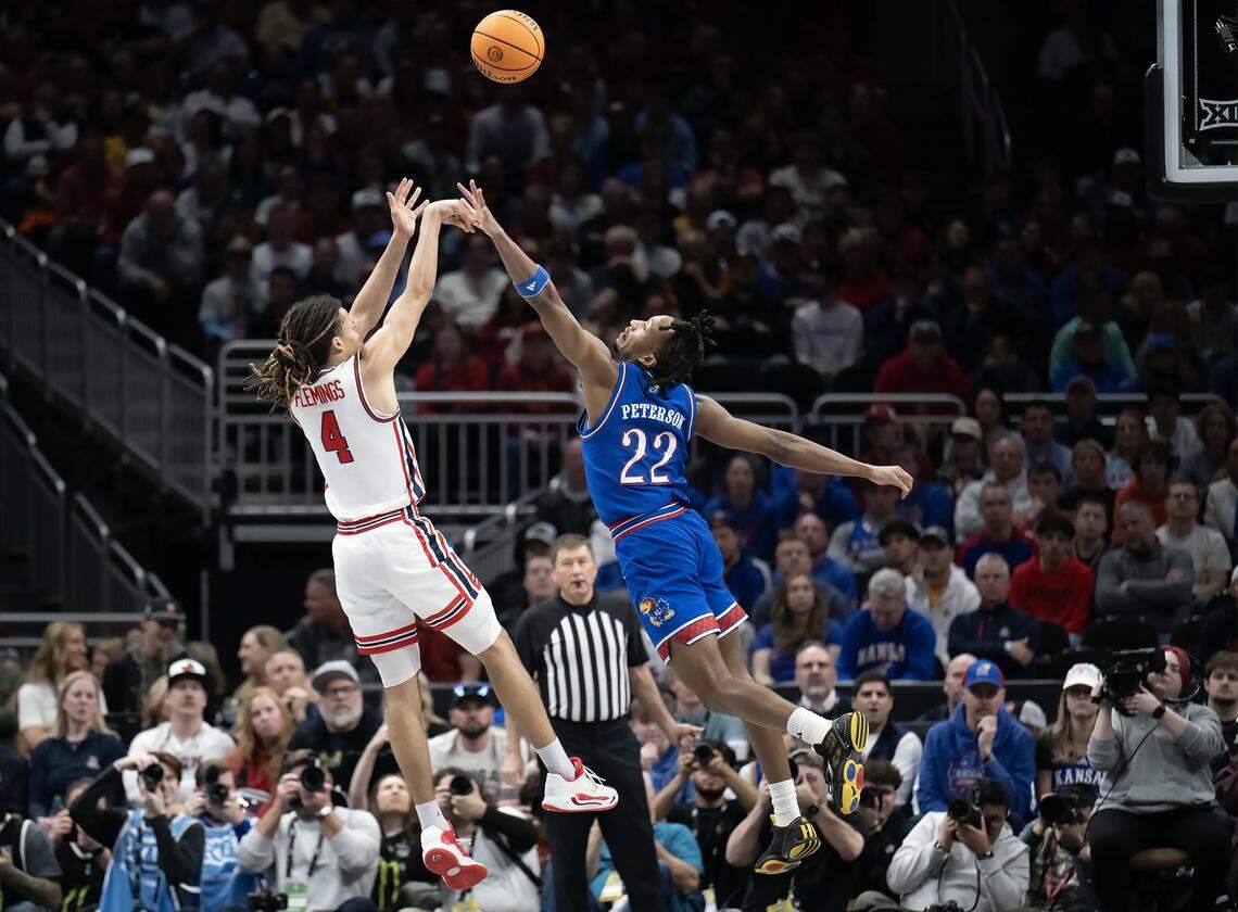 Houston Cougars guard Kingston Flemings (4, at left) shoots over Kansas Jayhawks guard Darryn Peterson (22) during a Big 12 Men's Basketball Tournament semifinal game at T-Mobile Center on Friday, March 13, 2026, in Kansas City.