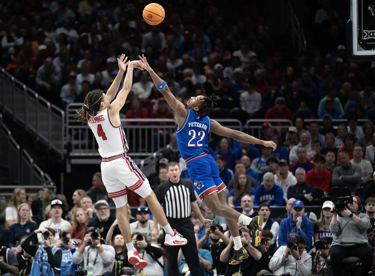Kansas Jayhawks guard Darryn Peterson (22) defends as Houston Cougars guard Kingston Flemings (4) shoots in the first half at the Big 12 Men's Basketball Tournament at T-Mobile Center on Friday, March 13, 2026, in Kansas City.