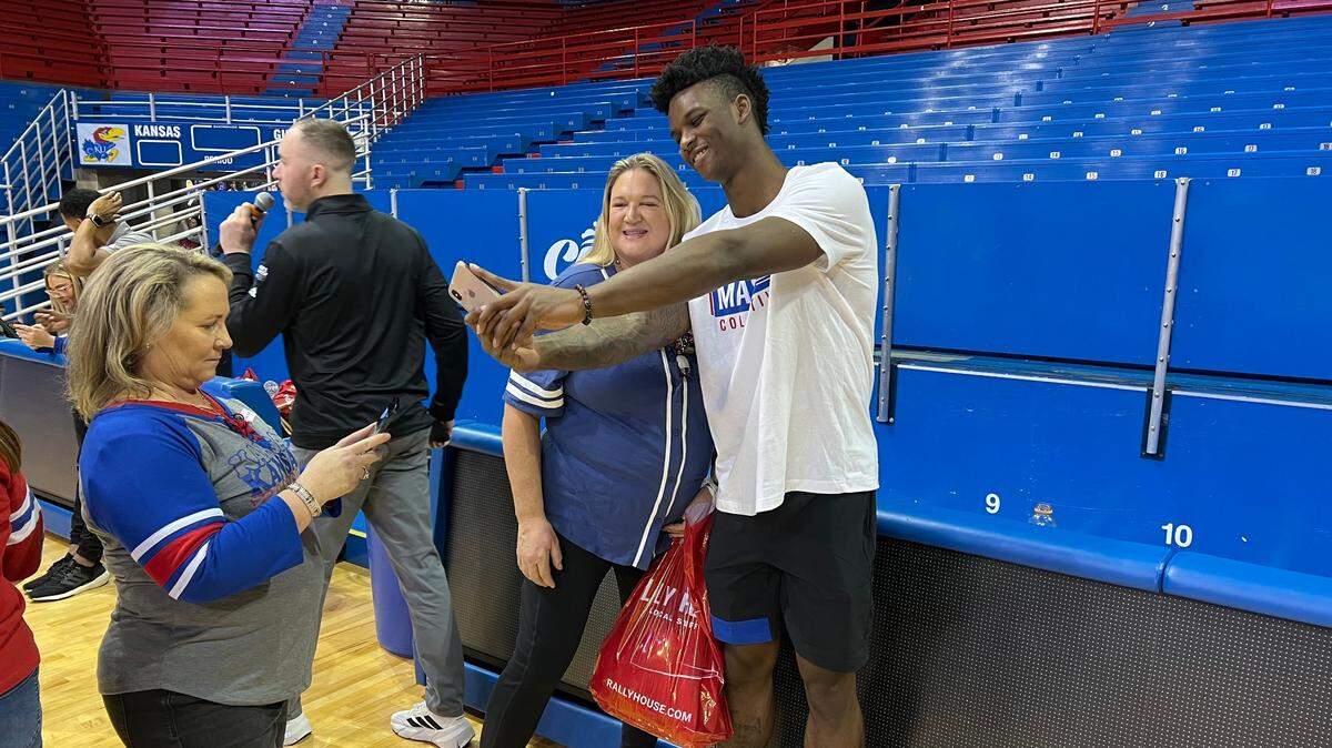Kansas sophomore forward KJ Adams takes pictures with fans at Wednesday’s Ladies Night Out NIL event at Allen Fieldhouse. About 400 women took part in drills, toured the facilities and participated in Q and A sessions.