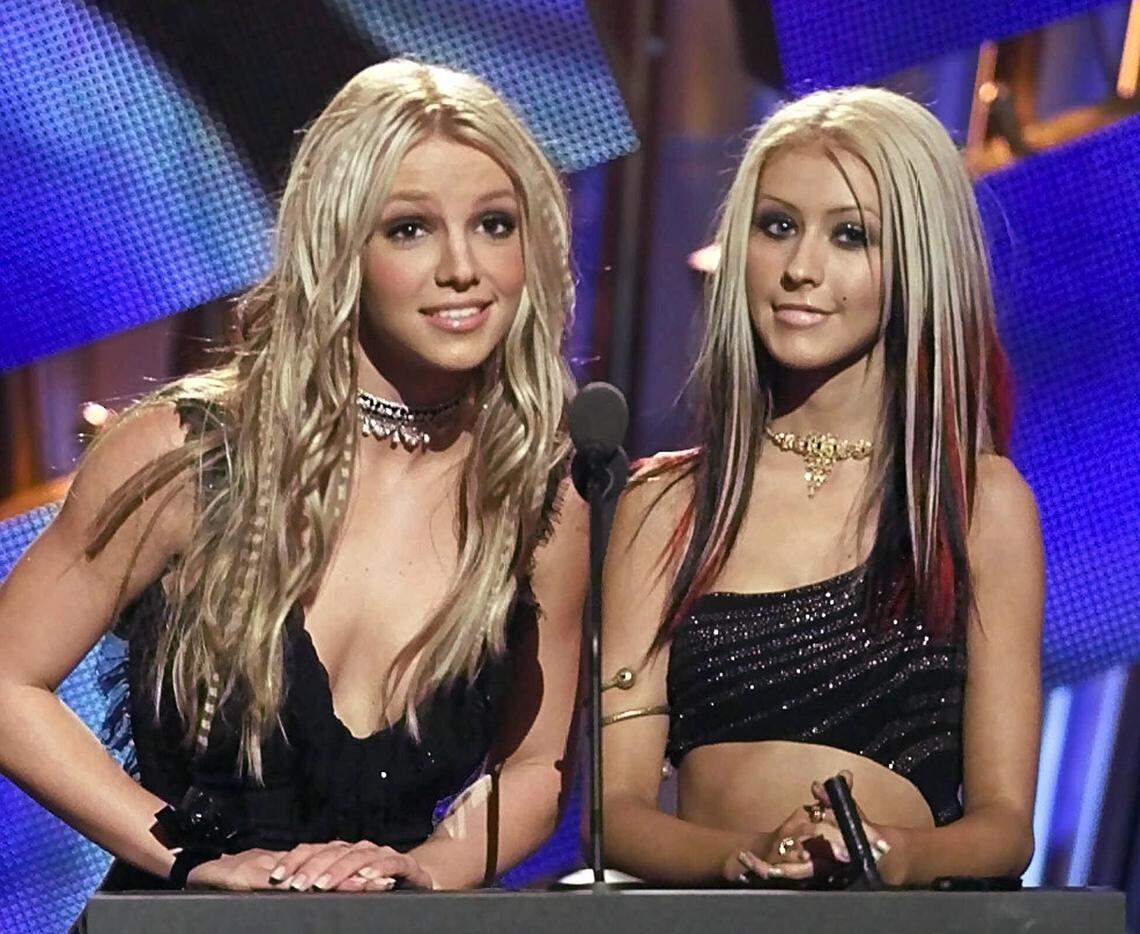 Pop stars Britney Spears, left, and Christina Aguilera introduce Whitney Houston at the 2000 MTV Video Music Awards Thursday, Sept. 7, 2000, at Radio City Music Hall in New York.