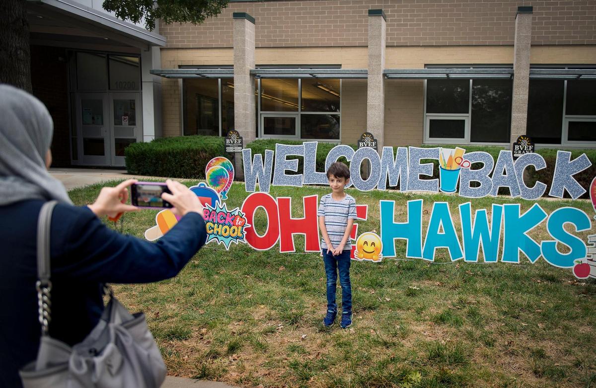 Fadia Khuffash of Overland Park took a photo of her son, Ahmad, 6, a first-grader, outside of Oak Hill Elementary School on Tuesday, Sept. 8, 2020, in Overland Park. Ahmad will be returning to the school on Wednesday for the hybrid in-person learning model. Oak Hill Elementary, in the Blue Valley School District, will have about 350 students returning this week for in-person learning and have 115 students learning as virtual students.