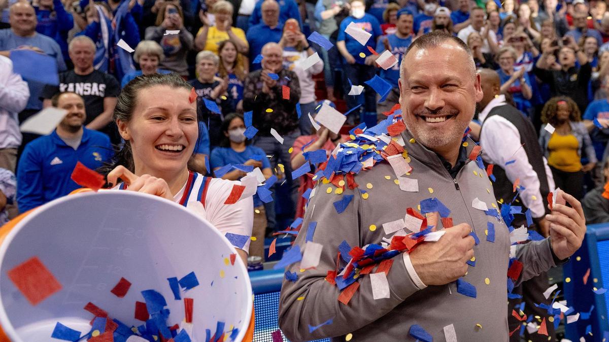 Kansas guard Holly Kersgieter (13) showers head coach Brandon Schneider with confetti after defeating Columbia 66-59 in an NCAA college basketball game in the final of the WNIT, Saturday, April 1, 2023, in Lawrence, Kan.