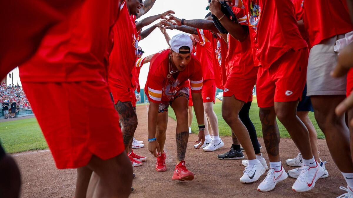 Patrick Mahomes runs through a celebration tunnel from his offensive teammates after hitting a home run during the Marquez Valdes-Scantling charity softball game Friday, June 9, 2023, at Legends Field in Kansas City, Kansas.