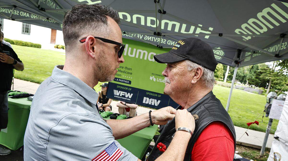Darin Davis presented a Vietnam War veteran with a commemoration pin at the Humana display May 28 in Washington, D.C.