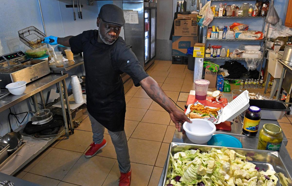 Chef Jah Kenya Seals, who recently opened Opal N Blues, works on an order.