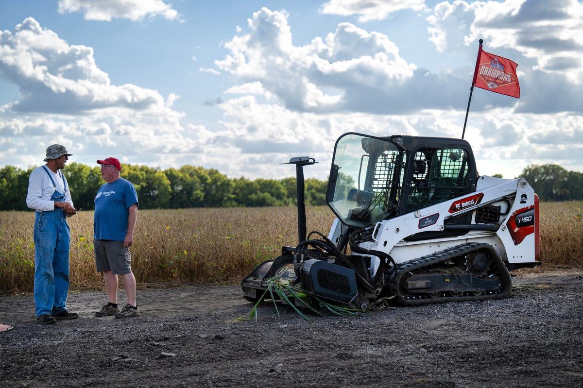 Jim Johnson, left, of Johnson Farms, talks with Rob Stouffer of Precision Mazes who spent eight hours cutting a Chiefs-themed corn maze in a field at the family fun farm on Monday, Sept. 16, 2024, in Belton.