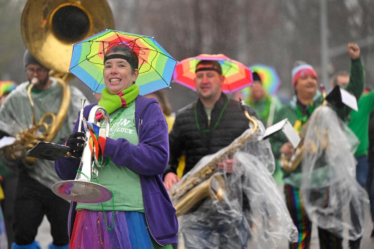 Members of the Mid America Freedom Band marched in the rain during the 2023 Brookside St. Patrick’s Day Warm-Up Parade on Saturday March 11, 2023 in Kansas City.