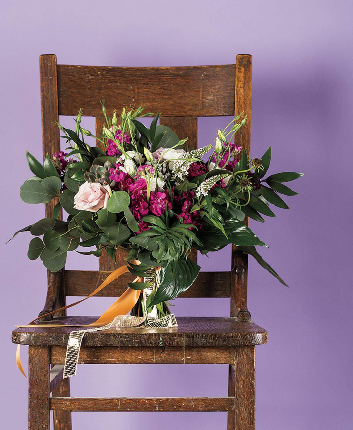 FRESH PICKS Silver dollar eucalyptus and nagi leaves bring the greenery to this bouquet of roses, veronica, scabiosa and ranunculus from Good Earth Floral Design Studio.