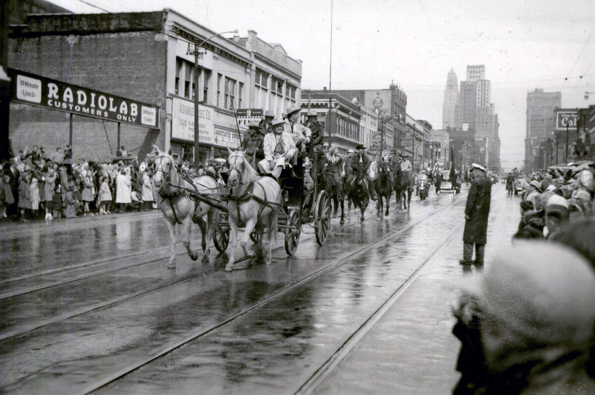 A stagecoach and horseback riders take part in the 1948 American Royal Parade.
