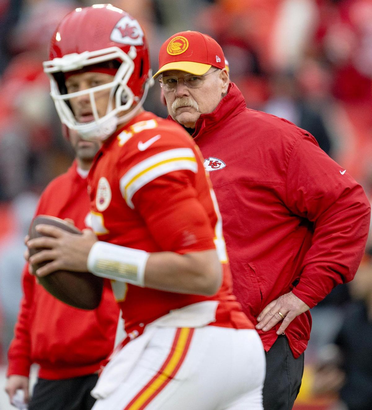 Kansas City Chiefs head coach Andy Reid watches quarterback Patrick Mahomes (15) warm up before an NFL football game against the Cincinnati Bengals at GEHA Field at Arrowhead Stadium on Sunday, Dec. 31, 2023, in Kansas City.