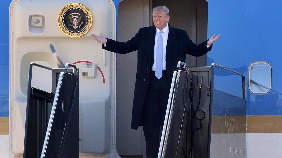 President Trump responds to the greeting he received from well-wishers when he arrived Wednesday at St. Louis Lambert International Airport.