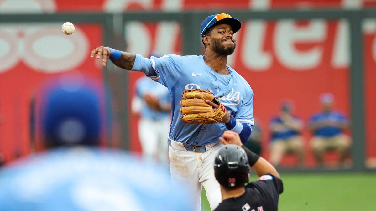 Kansas City Royals third baseman Maikel Garcia throws to first over Cleveland Guardians outfielder Steven Kwan during the fifth inning of Saturday’s game at Kauffman Stadium.