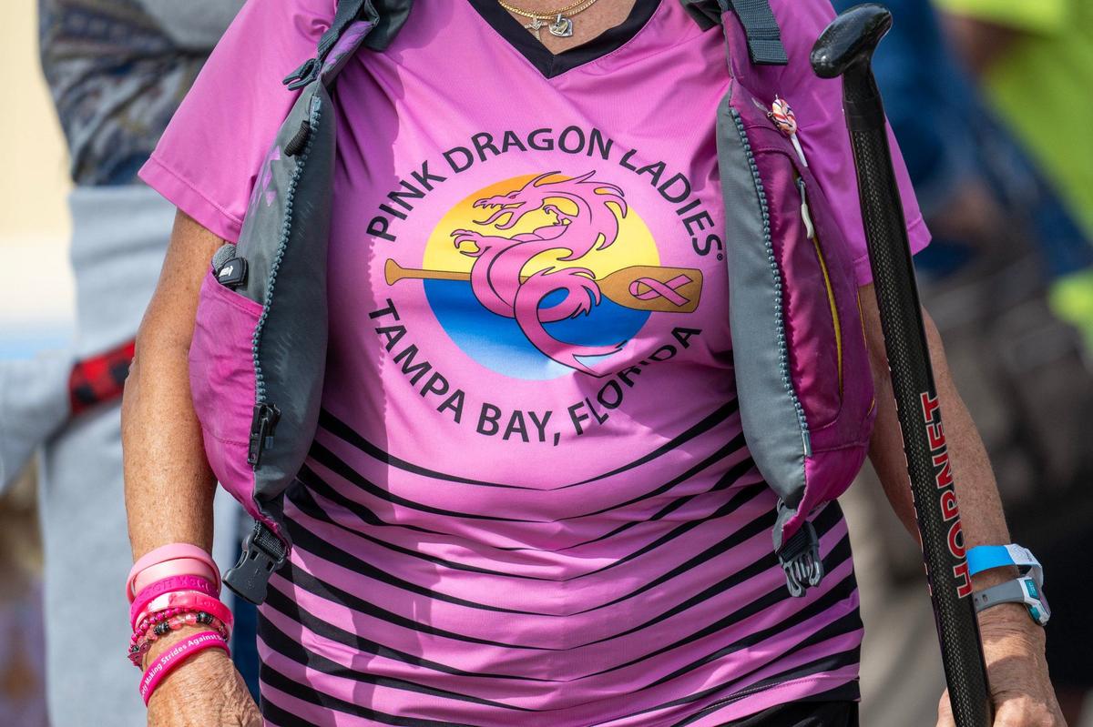 A crew member from the team Pink Dragon Ladies of Tampa Bay, Florida, walks around during the KC Dragon Boat Festival at Shawnee Mission Park on Saturday, Sept. 28, 2024.