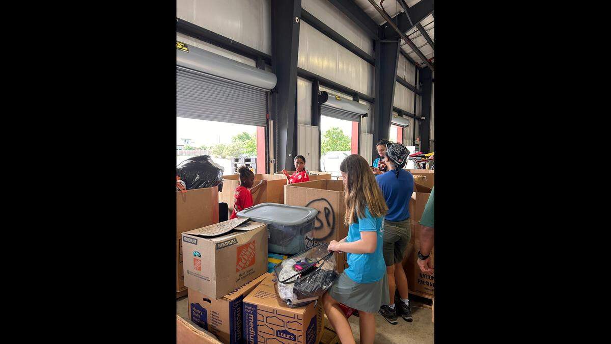 Volunteers pack items with the Priest Holmes Foundation in Kerr County Texas July 12.