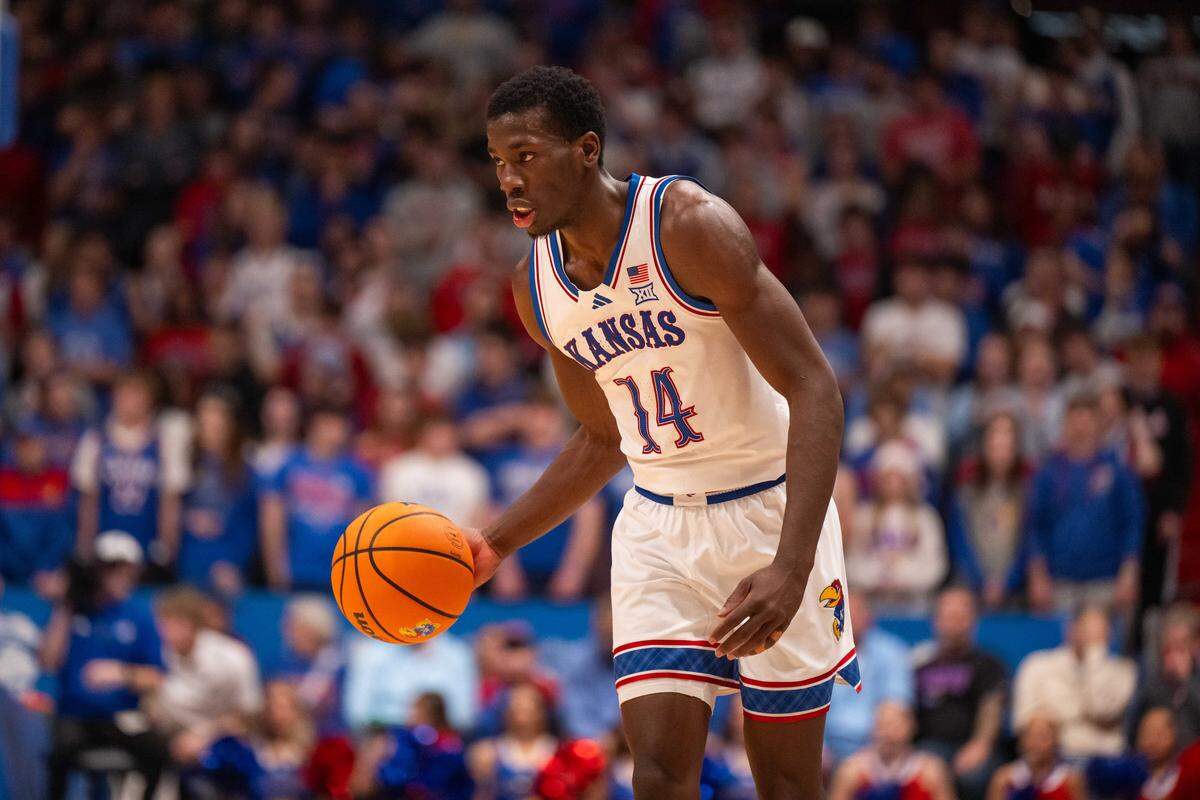 Kansas Jayhawks guard Melvin Council Jr. (14) dribbles the ball up the court in the first half vs. the Towson Tigers on Tuesday, December 16, 2025, at Allen Fieldhouse.