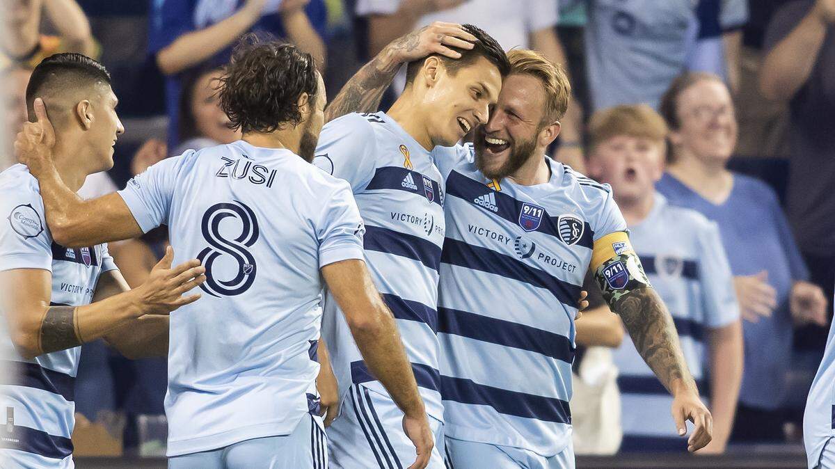 Sporting Kansas City forward Johnny Russell (7) celebrates with Sporting Kansas City forward Daniel Salloi (20) after scoring the teams second goal during the match between Sporting Kansas City and the the Chicago Fire on Saturday September 11, 2021 at Children’s Mercy Park in Kansas City, KS. (Nick Tre. Smith/ Special to the Star)
