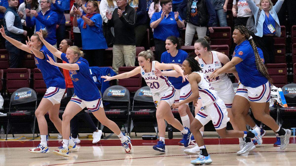 Kansas players celebrate after defeating Georgia Tech in a first-round women’s NCAA Tournament game Friday in Stanford, Calif.
