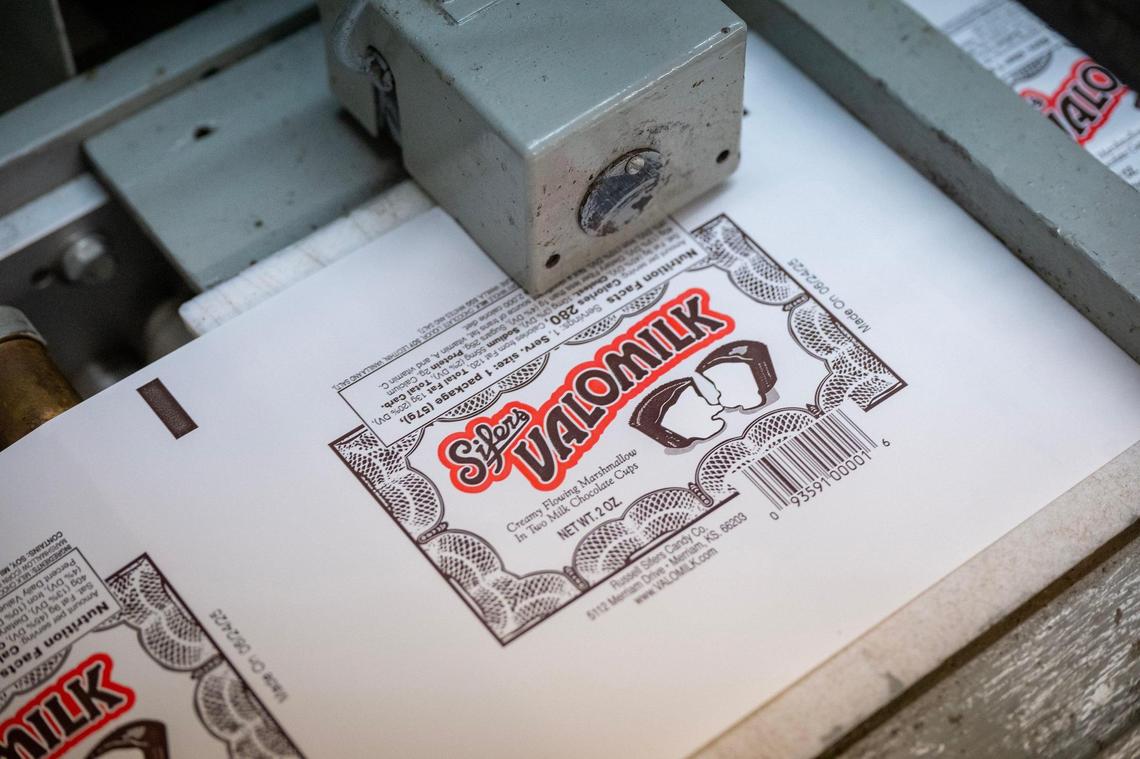 A wrapper destined for a twin pack of Valomilk cups makes its way through the company’s mid-century machinery in Merriam.