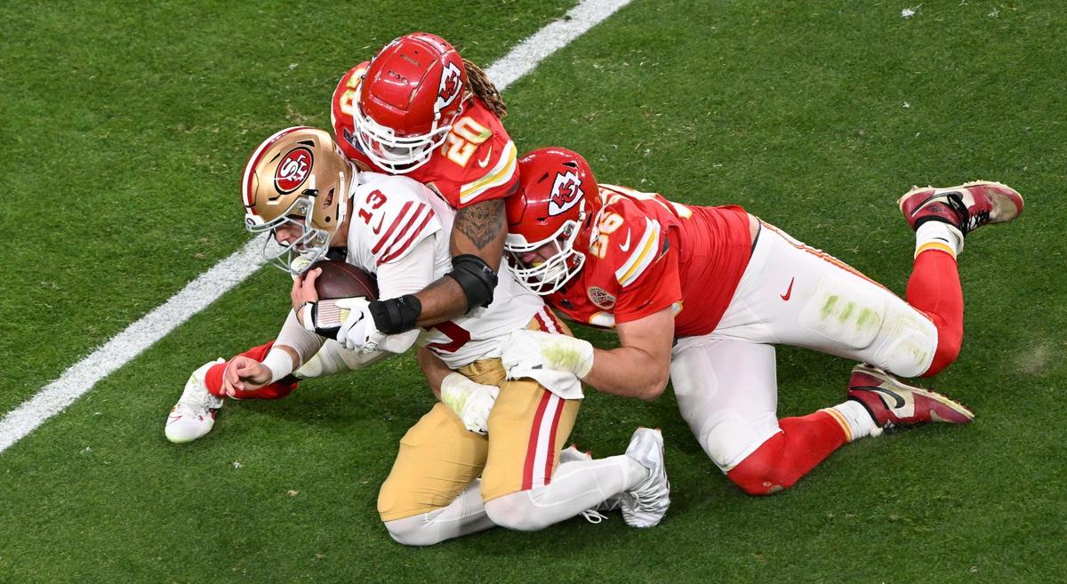 San Francisco 49ers quarterback Brock Purdy (13) is tackled by Kansas City Chiefs safety Justin Reid (20) and defensive end George Karlaftis (56) in the first half of Super Bowl LVIII, Sunday, Feb. 11, 2024, in Las Vegas.