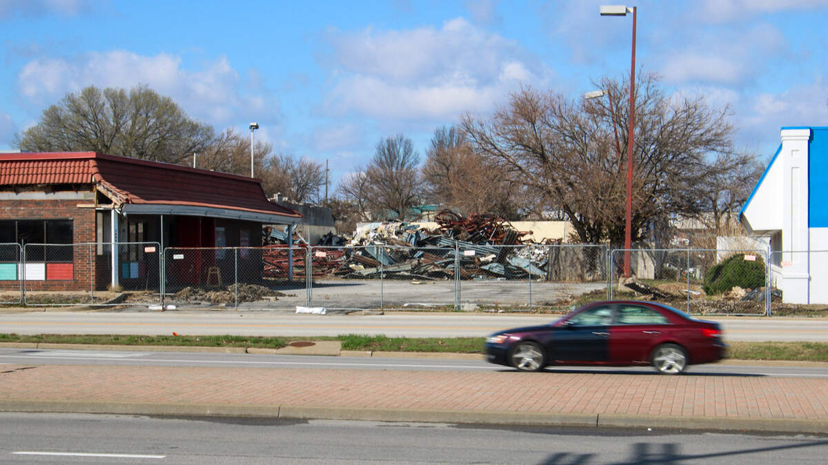 Vehicles drive on Sante Fe Street on March 11, 2026, as nearby buildings undergo demolitions ahead of the Interstate 35 and Santa Fe interchange project in Olathe.