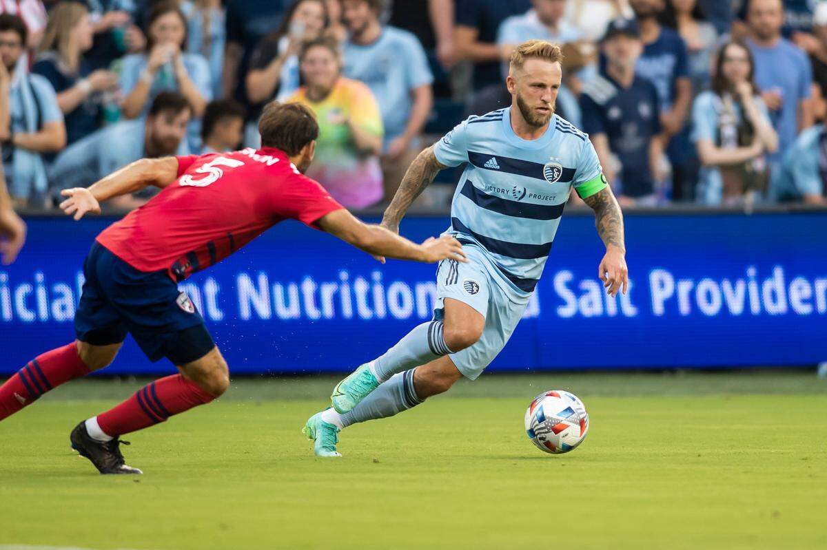 Sporting Kansas City forward Johnny Russell (right) attempts to maneuver around FC Dallas midfielder Facundo Quignon during a July match at Children’s Mercy Park in Kansas City, Kansas.