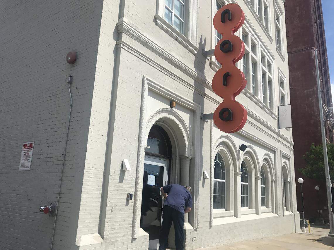 A locksmith changes the locks Monday at Nara in the Crossroads.
