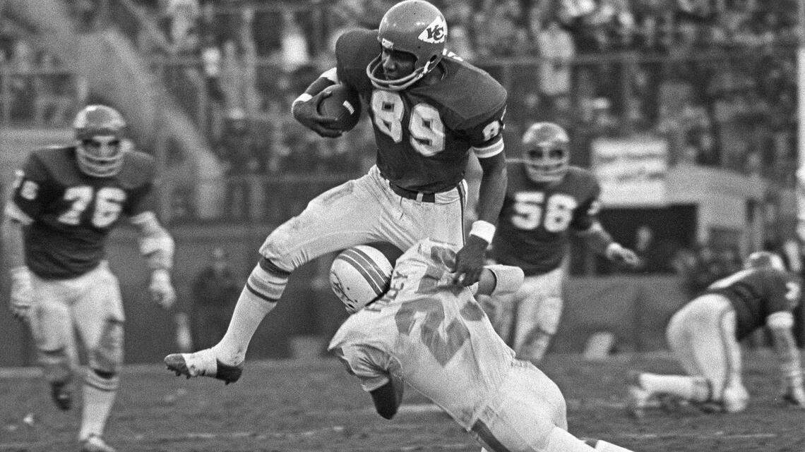 Chiefs wide receiver Otis Taylor jumps over Miami Dolphins cornerback Tim Foley after catching a pass at Municipal Stadium during the 1971 AFC Divisional Playoff game.