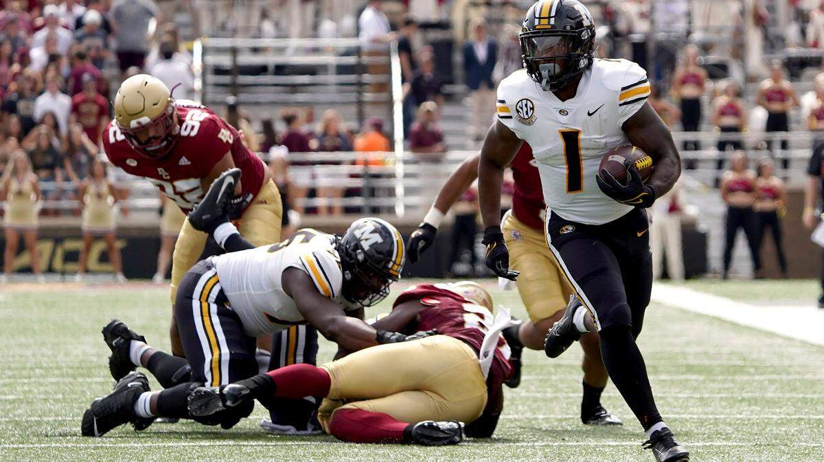 Missouri running back Tyler Badie (1) breaks free from the pile as he rushes for a gain during the first half of an NCAA college football game against Boston College, Saturday, Sept. 25, 2021, in Boston. (AP Photo/Mary Schwalm)